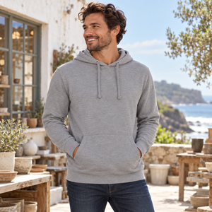 Next Level 9301 Unisex Laguna Hoodie Sweatshirt in Heather Grey/ Heather Grey — man at a coastal pottery studio courtyard on a cool bright morning
