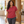 Woman wearing the Nike 203697 polo in Pro Red, realistic lifestyle photo